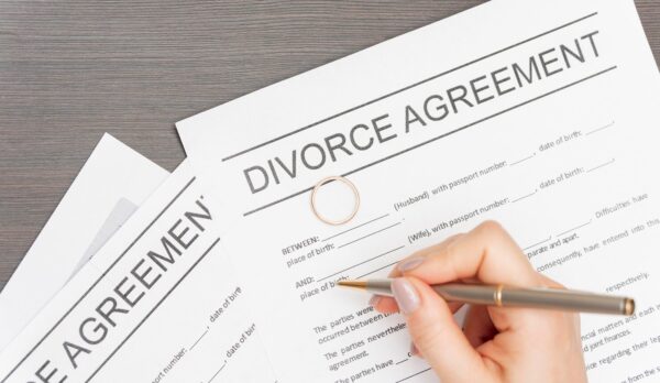 close-up-hand-signing-divorce-agreement_23-2148558452